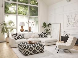 DFS Calix right hand facing large chaise end sofa in in ivory boucle, Calix pattern large square footstool, and Calix ripple accent chair in ivory boucle.